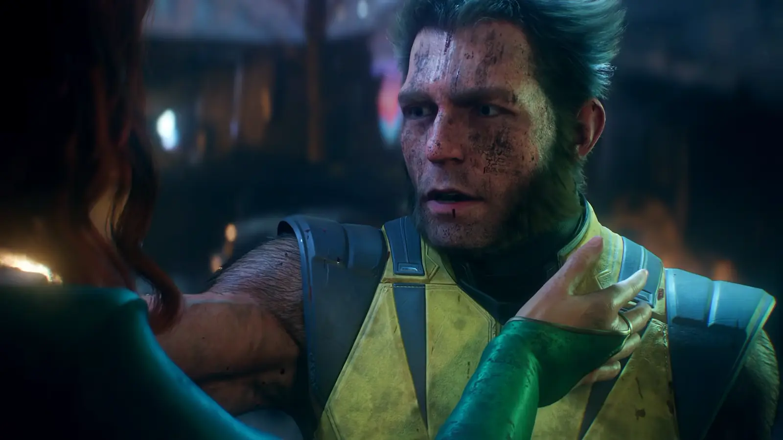 Logan sin máscara, con el rostro sucio y el traje amarillo, frente a Jean Grey en Marvel's Wolverine