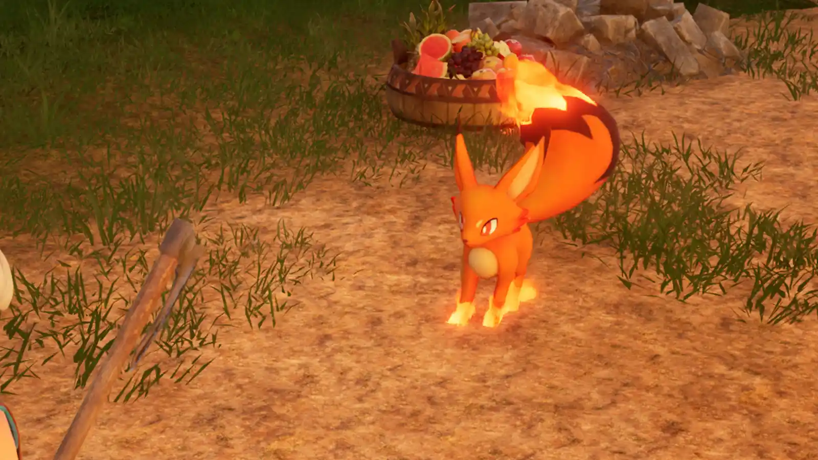Foxparks, el Pal zorro de fuego naranja, junto a una canasta de comida en Palworld