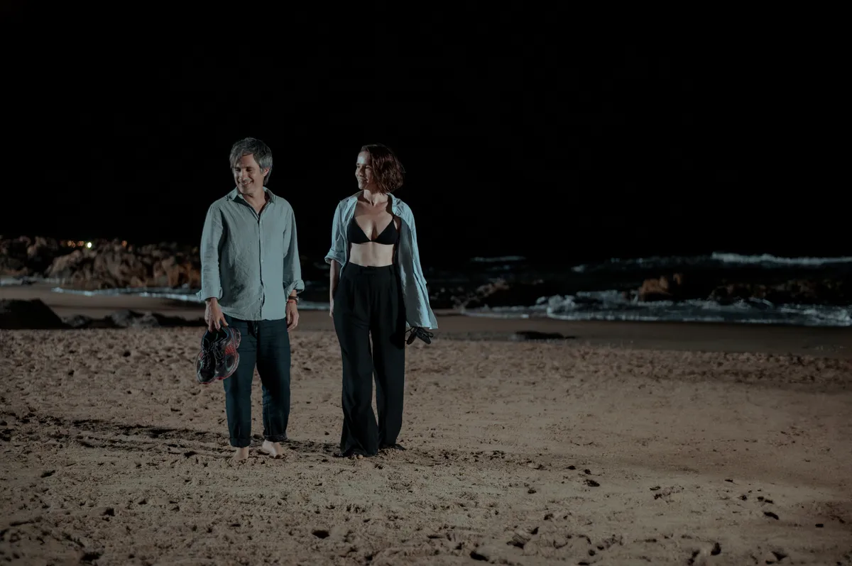 Natalia Oreiro y Gael García Bernal caminan juntos por la playa de noche en Nada entre los dos
