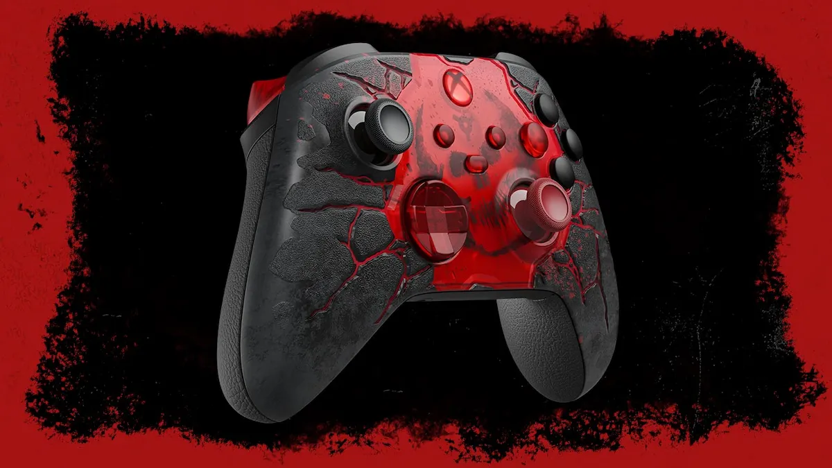 Control Xbox Gears of War E-Day en vista tres cuartos, con la textura de asfalto agrietado gris y las vetas rojas