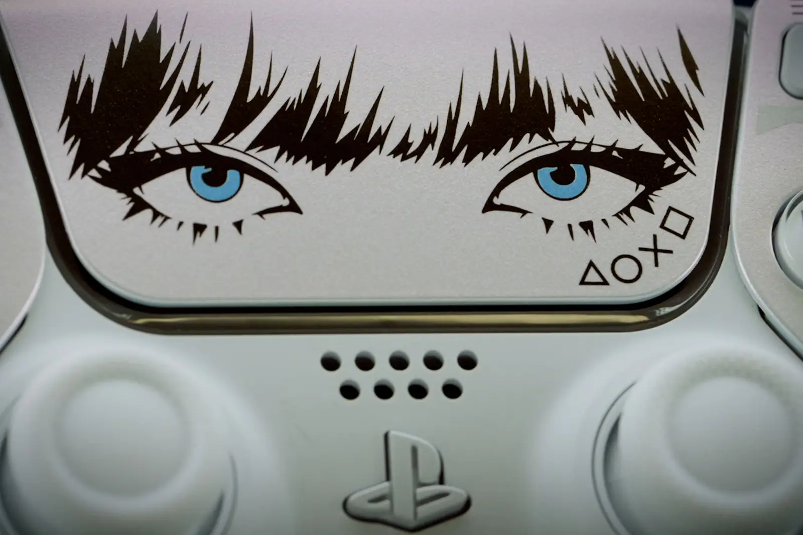 Primer plano del panel táctil del DualSense Lisa Limited Edition con los ojos de la cantante dibujados