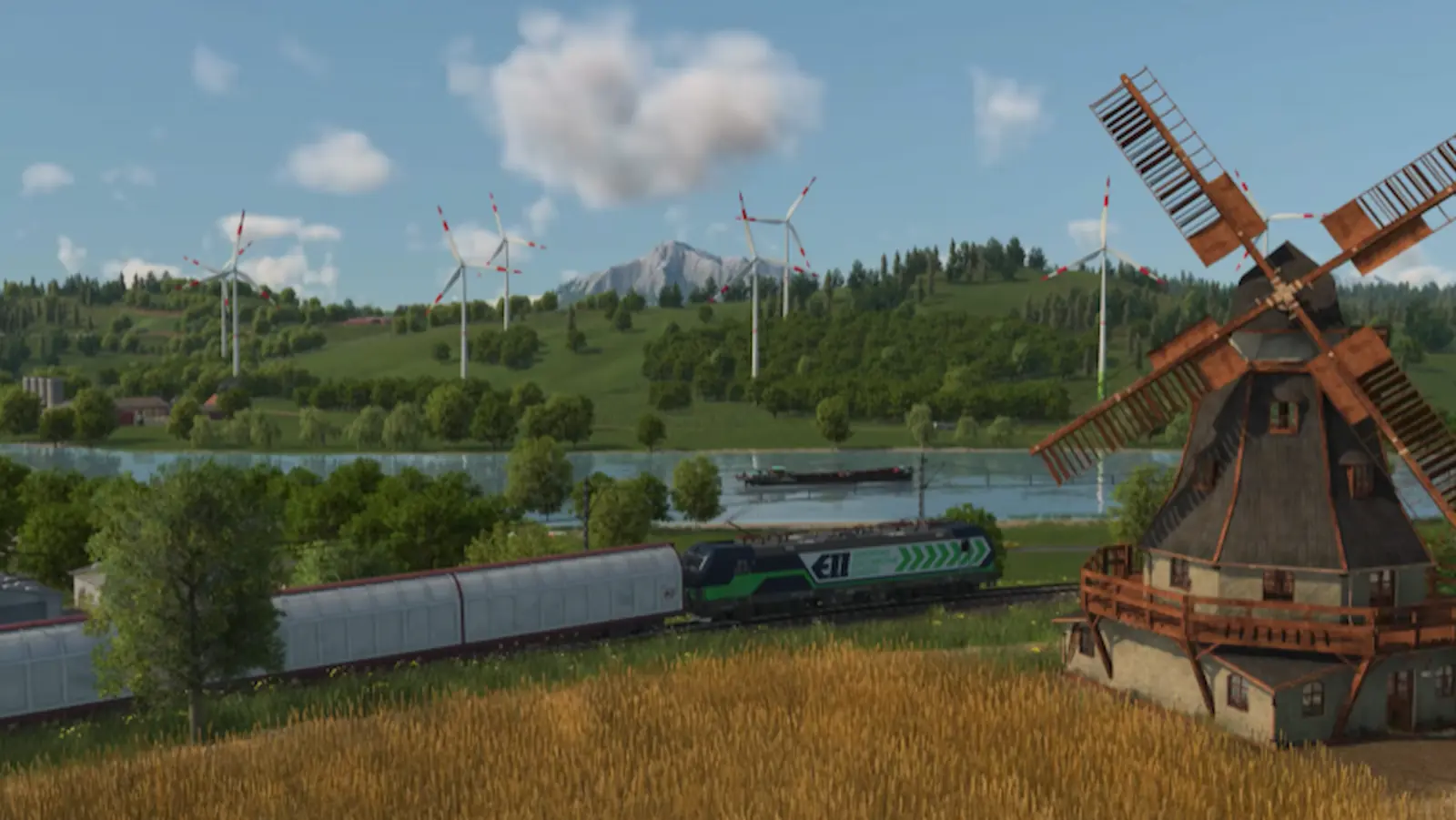 Molino de viento antiguo, tren de carga y turbinas eólicas conviviendo en Transport Fever 3
