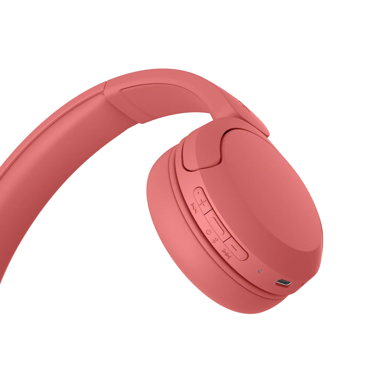 Primer plano de los botones de los auriculares Sony WH-CH530 en color coral