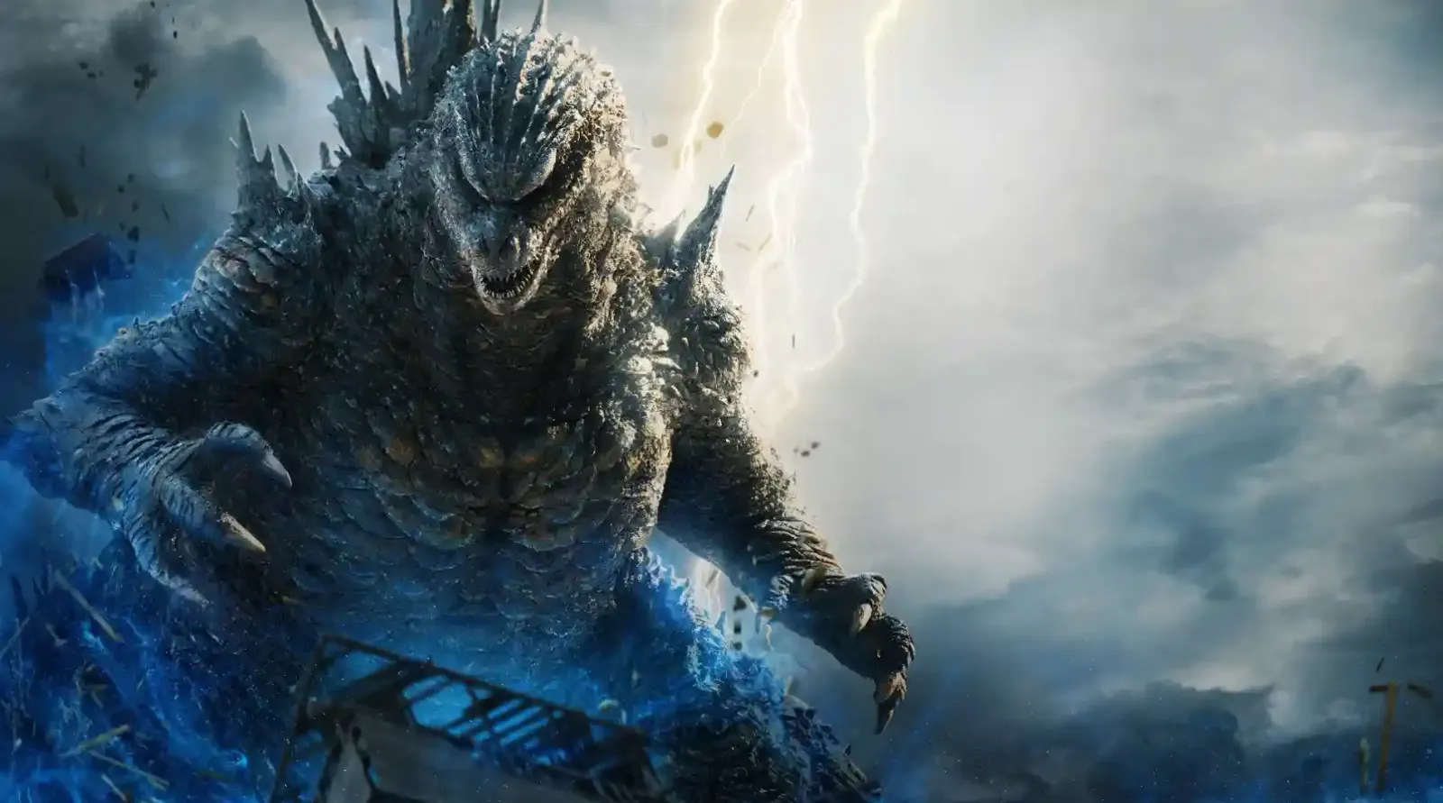 Godzilla, con las placas dorsales encendidas en azul y rayos de fondo, en una imagen de Godzilla Minus Zero
