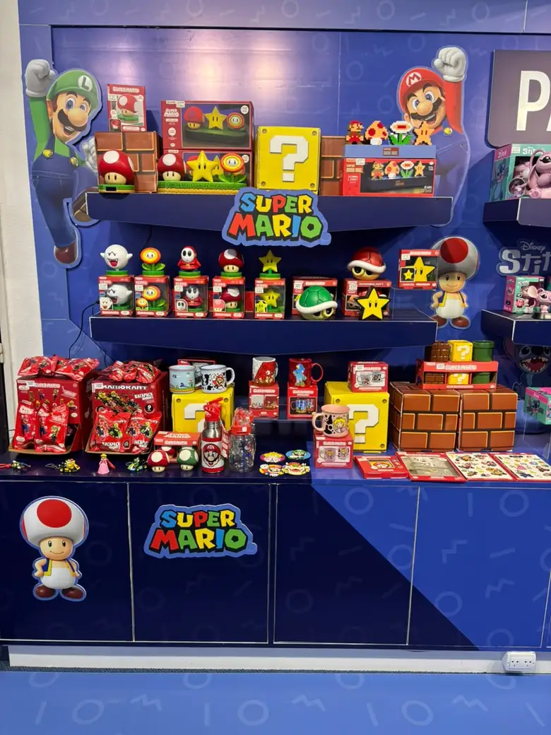 Exhibidor de Super Mario en Vulcanita Collector con figuras, tazas, bloques de signo de pregunta y otros objetos de la franquicia